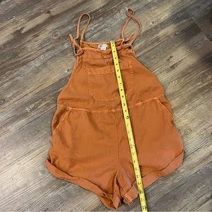 Billabong romper in Medium. Rust color, lightweight material.